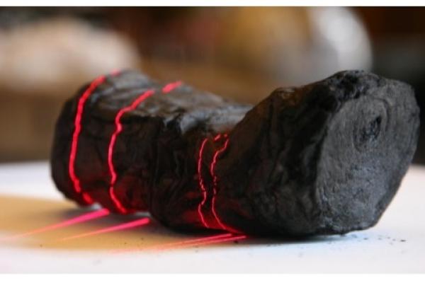 Herculaneum scroll with red laser lines being scanned at Institut de France by Brent Seales and his team.